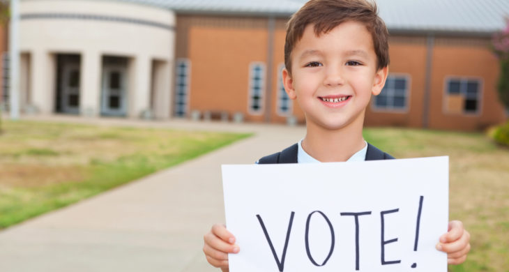 Child with vote sign