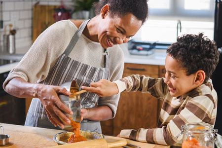 Mother and son baking togethe