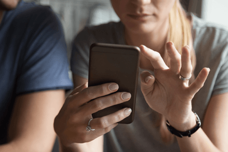 women holding mobile phone
