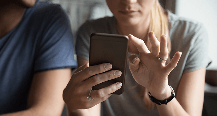 women holding mobile phone