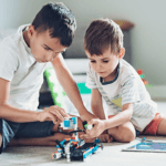Two boys building a robot