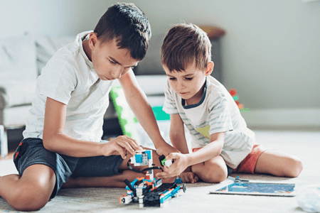 Two boys building a robot
