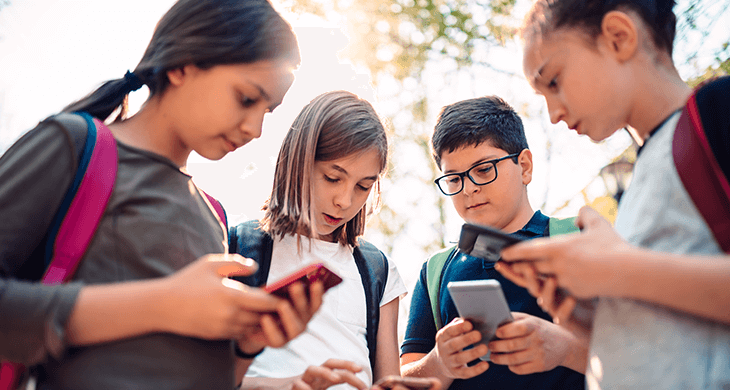 group of kids using cell phones for social media