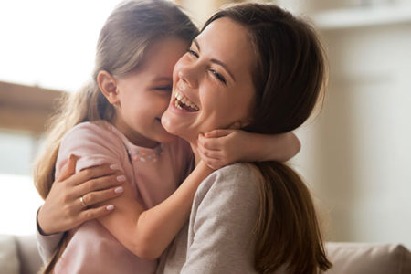 mom and daughter laughing