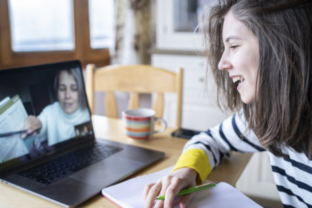Teacher talking to a student online learning